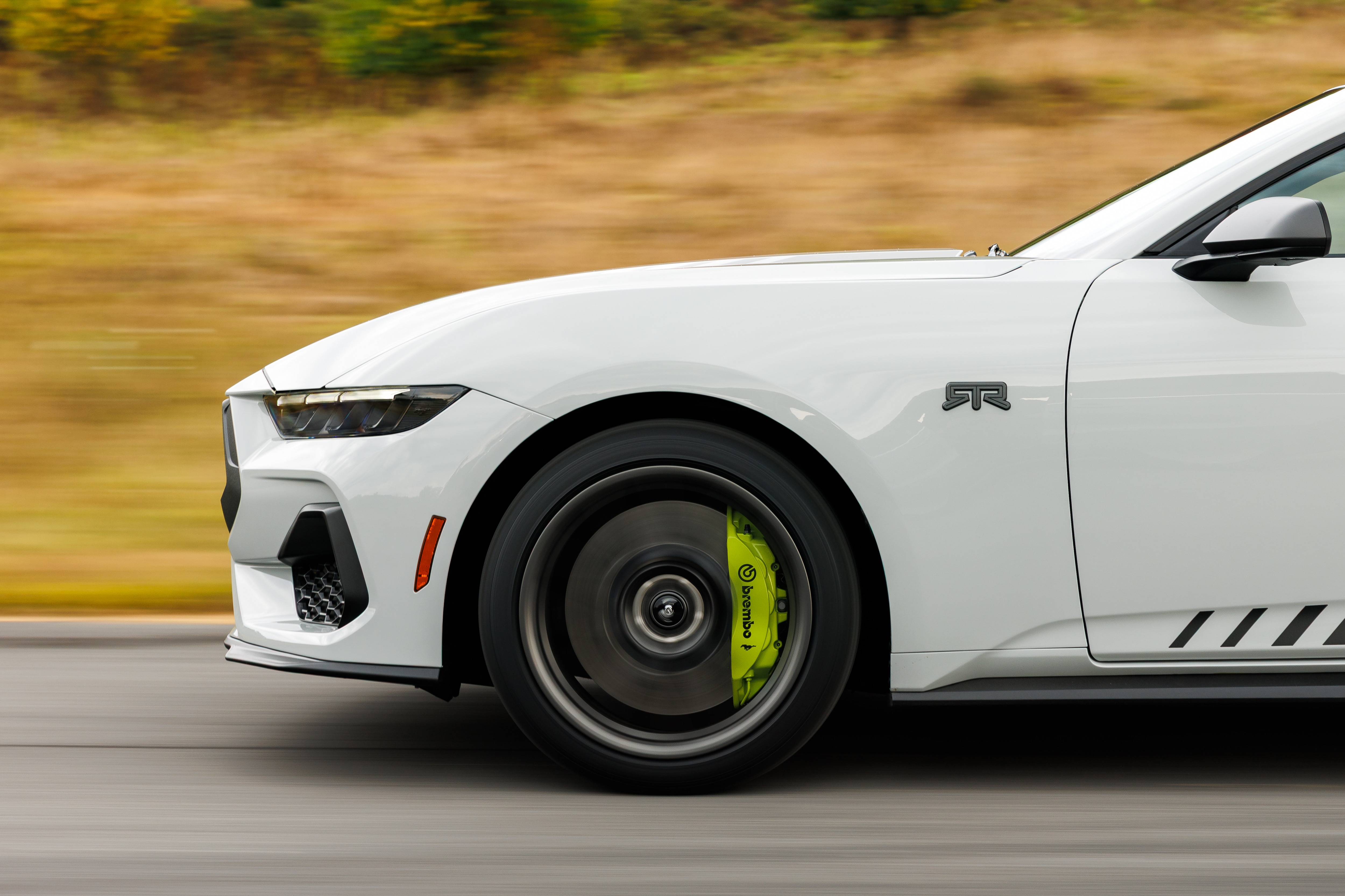 Optional RTR package available on 2026 Ford Mustang EcoBoost fastback. Preproduction model shown with optional Hyper Lime brake caliper shown. Available late spring 2026.